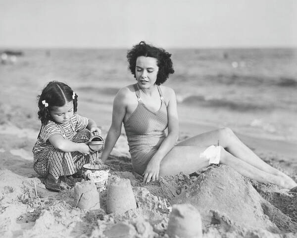 Mid Adult Women Art Print featuring the photograph Mother With Girl 2-3 Playing In Sand On by George Marks