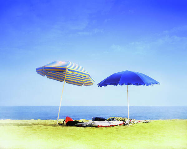 Empty Art Print featuring the photograph Two Sunshades Over Clothes, Towels And by Gandee Vasan