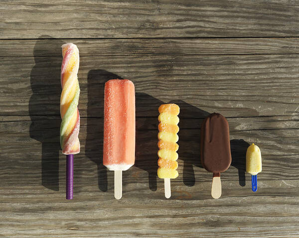 In A Row Art Print featuring the photograph Row of assorted ice cream lollies by Henrik Sorensen