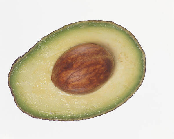 White Background Art Print featuring the photograph Slice of Avocado Containing a Seed by Digital Vision.