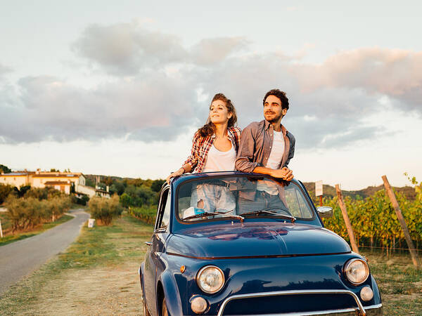 Young Men Art Print featuring the photograph Young Couple Trip With Vintage Car #1 by FilippoBacci