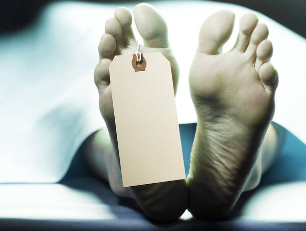 The End Art Print featuring the photograph Dead person on autopsy table with name tag on toe, low section by Jeffrey Coolidge