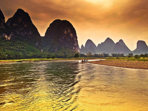 Sunset Art Print featuring the photograph Riverside scenery like gold-China Guilin scenery Lijiang River in Yangshuo by Artto Pan