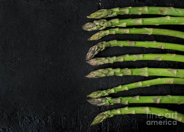 Asparagus Art Print featuring the photograph Asparagus on rustic black background by Jelena Jovanovic