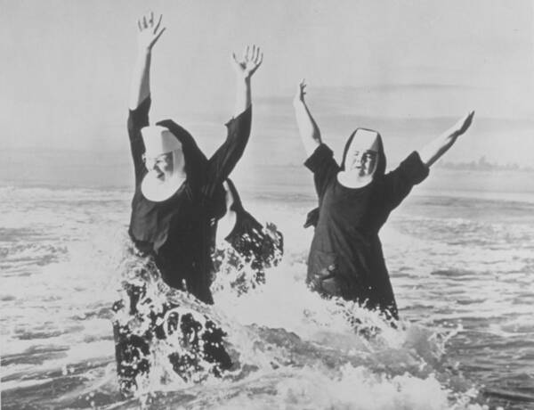 People Art Print featuring the photograph Nuns In The Surf by American Stock