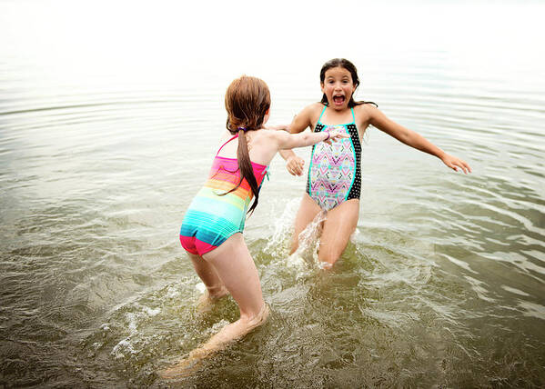Two Young Girls In Swimsuits Playing In A Lake Art Print by Cavan Images -  Pixels