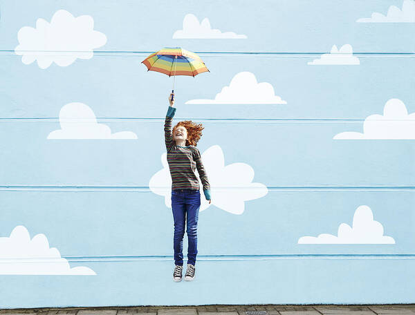 Child Art Print featuring the photograph Girl jumping with umbrella #1 by Flashpop