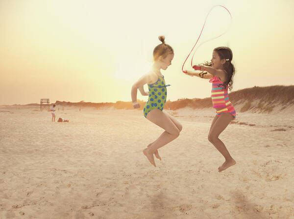4-5 Years Art Print featuring the photograph Girls jumping rope on beach by Jose Luis Pelaez Inc
