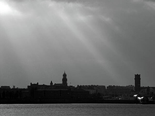 Liverpool; River Mersey; Black And White; Landscape; Cityscape; Skyline; Great Britain; Merseyside; Wirral Birkenhead; Sunbeams; Silhouette; Sky; Clouds; England; Art Print featuring the photograph Mersey Sunbeams by Lachlan Main