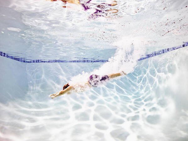 Motion Art Print featuring the photograph Young male swimmer diving into pool by Thomas Barwick