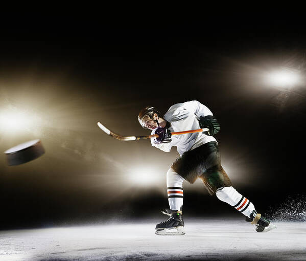 Human Arm Art Print featuring the photograph Ice Hockey Player Shooting Puck by Robert Decelis Ltd
