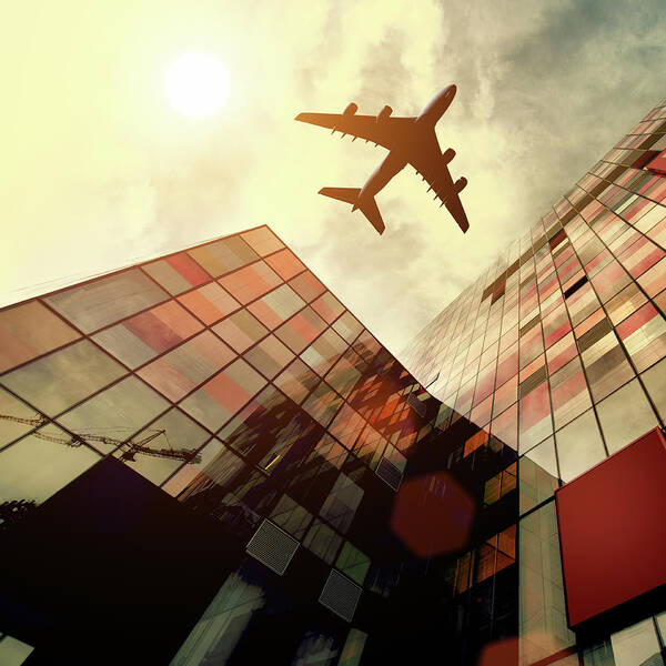 Downtown District Art Print featuring the photograph Airplane Flying Over Building by Teekid