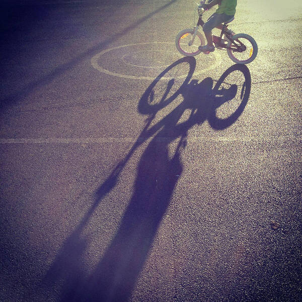 Shadow Art Print featuring the photograph Long Shadow Of Child Riding A Bicycle by Jodie Griggs