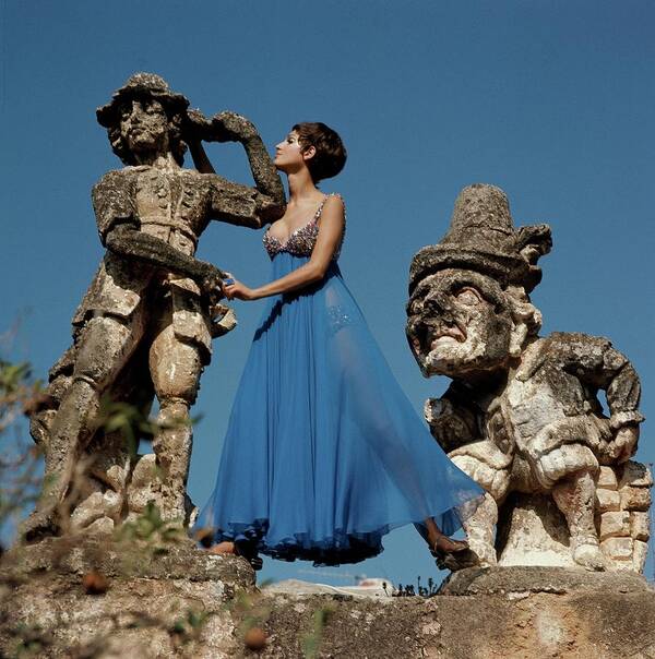 Fashion Art Print featuring the photograph Model Standing Between Statues At The Villa by Henry Clarke