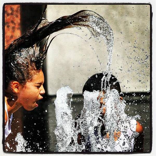  Art Print featuring the photograph A Girl Finds A Splash Of Cool Water At by Ringo Chiu