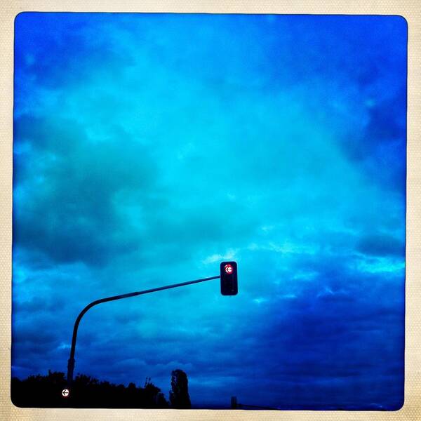 Traffic Light Art Print featuring the photograph Red traffic light and cloudy blue sky by Matthias Hauser
