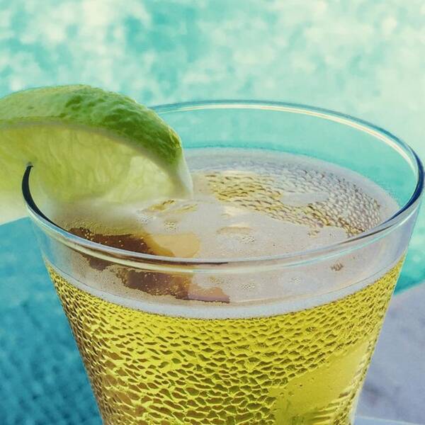 Food Art Print featuring the photograph Glass Of Beber With Lime By A Pool by Juan Silva