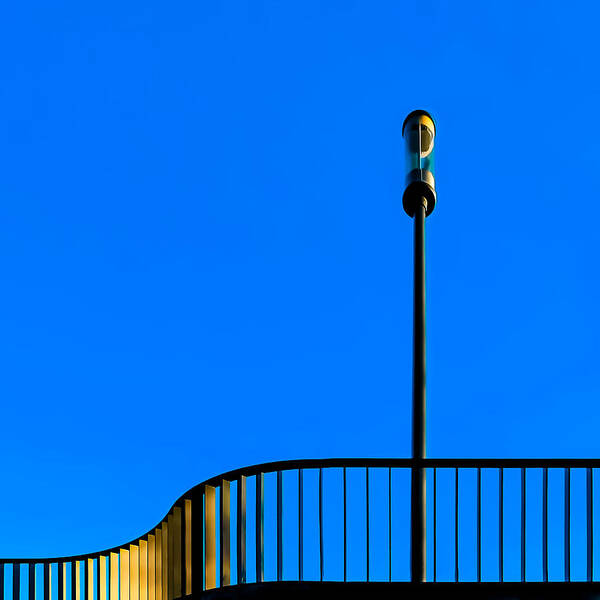 Railing
Light
Golden Light
Street Lamp
Blue Hour Art Print featuring the photograph Golden Light by Markus Auerbach