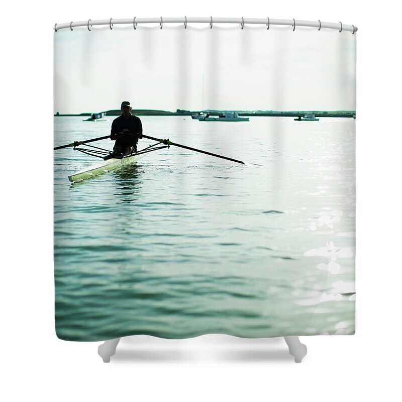 People Shower Curtain featuring the photograph A Mature Man In A Rowing Boat On The by Mint Images/ Jamie Kripke