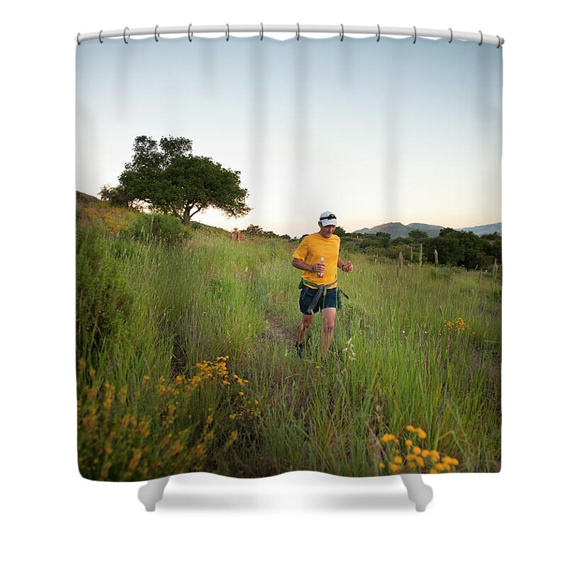 Adult Shower Curtain featuring the photograph A Trail Runner Passes Wildflowers by Kevin Steele