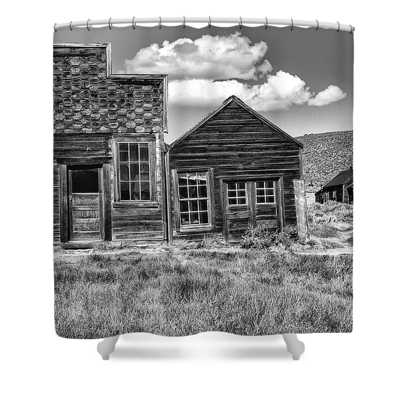 Black & White;black + White;monochrome;black And White;architecture;detail;details;cabins;structures;wood;windows;doors;door;window;buildings;dilapidated;rundown;abandoned;forlorn;derelict;empty;sandra Bronstein;clouds;doorways;entrances;old West;out West;bodie;ghost Town;ghost Towns;california;gold Rush Days;mining;houses;house;residence;horizontal;fine Art Photography;iconic;travel;tourism;historical;state Park;popular;dated;unoccupied;panes;glass;western United States;canvas; Shower Curtain featuring the photograph Days of Glory Gone by Sandra Bronstein