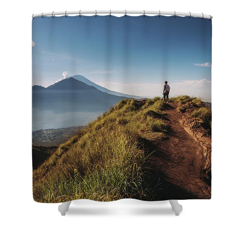 Shadow Shower Curtain featuring the photograph Hiker Staying On Top Of Mount Batur by Alex Grabchilev / Evgeniya Bakanova