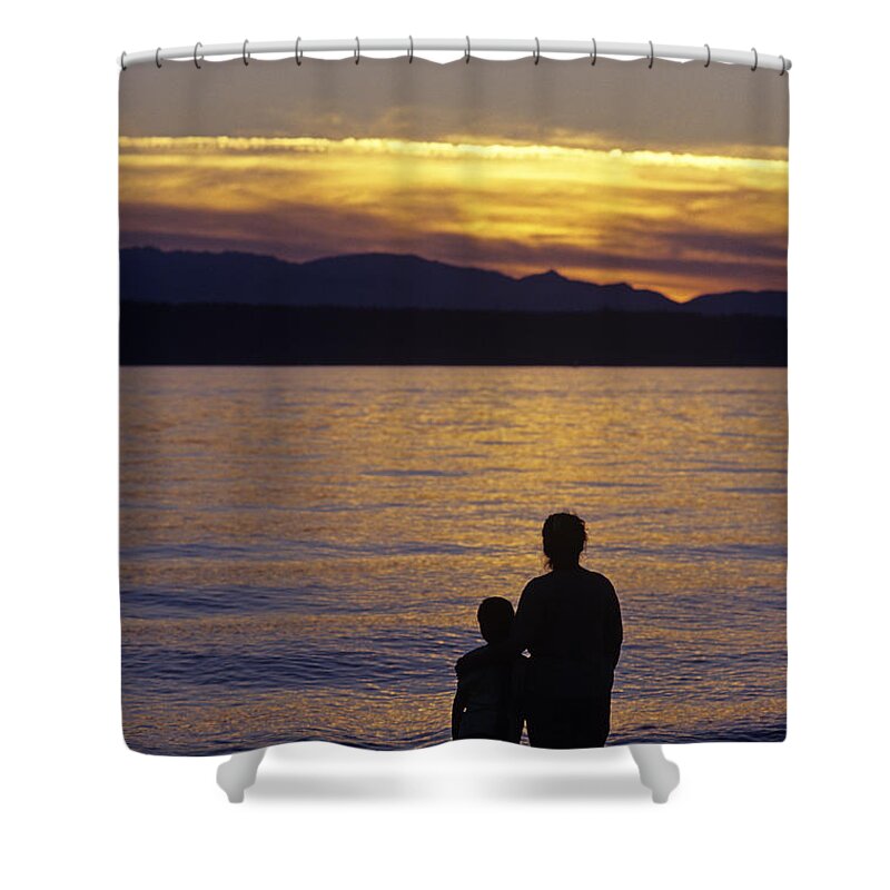 Travel Shower Curtain featuring the photograph Mother and daughter holding each other along Edmonds Beach at su by Jim Corwin