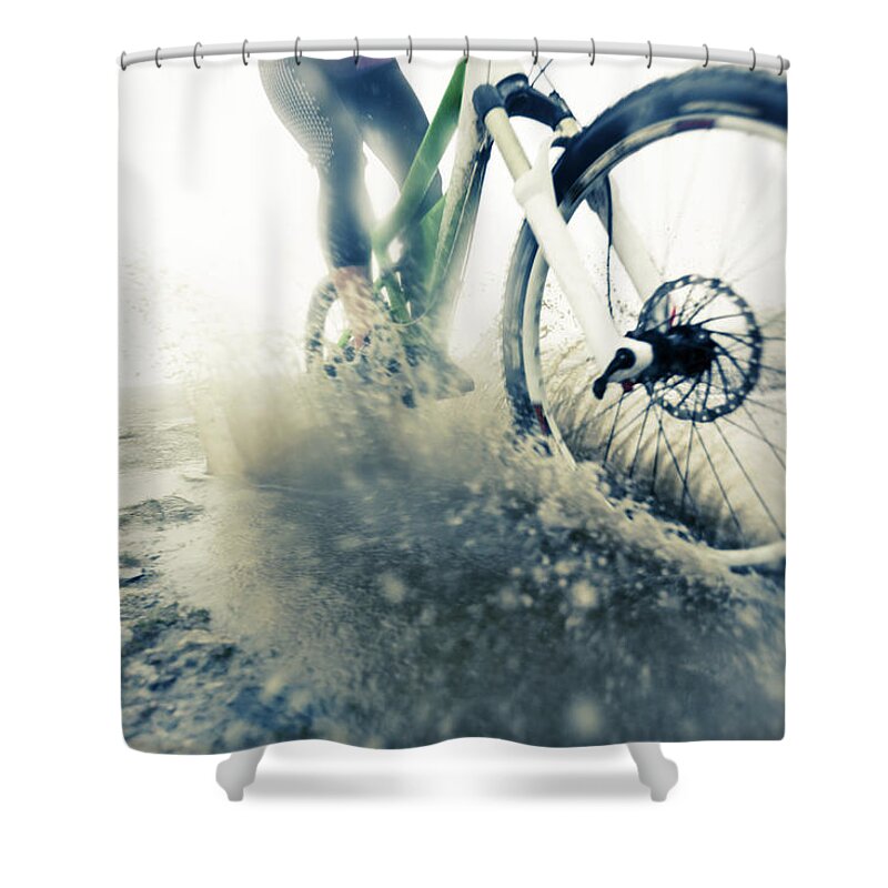 People Shower Curtain featuring the photograph Mountain Biker Racing Through Puddle by Nullplus