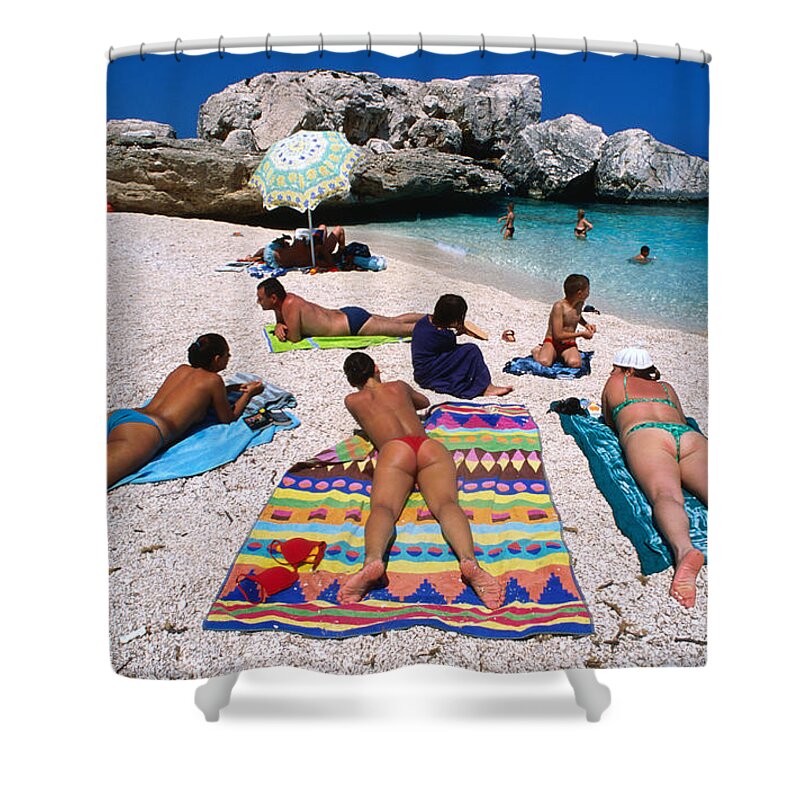 Recreational Pursuit Shower Curtain featuring the photograph People Sunbathing On The Beach At Cala by Dallas Stribley