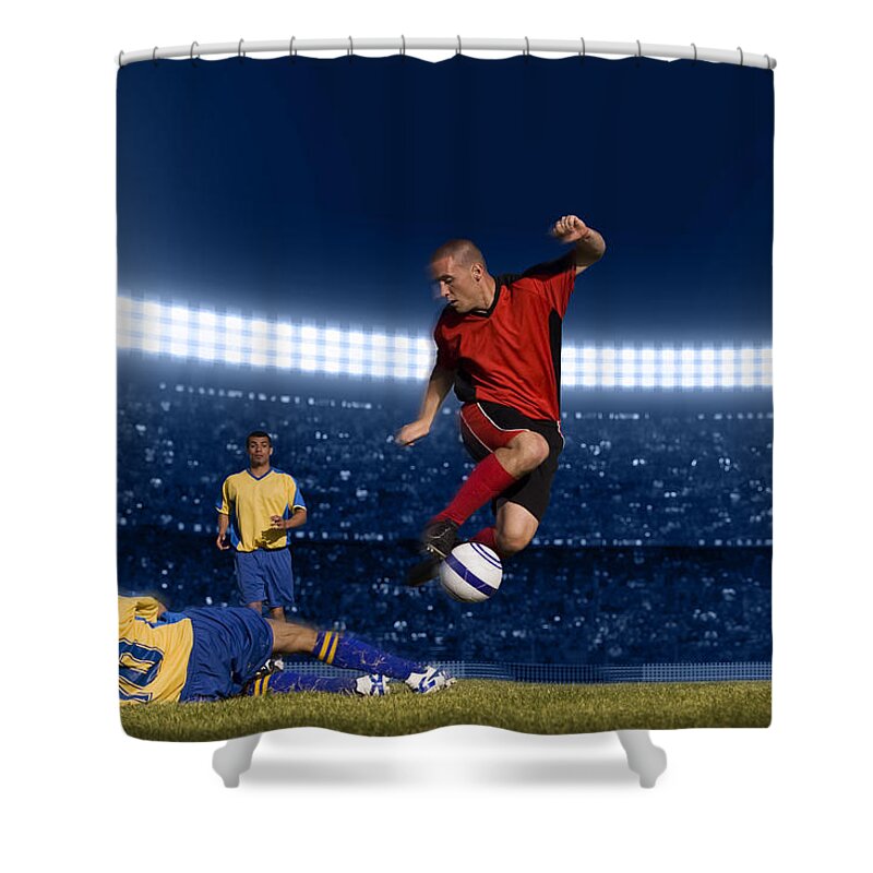 Expertise Shower Curtain featuring the photograph Soccer Player Jumping With Ball by Kycstudio