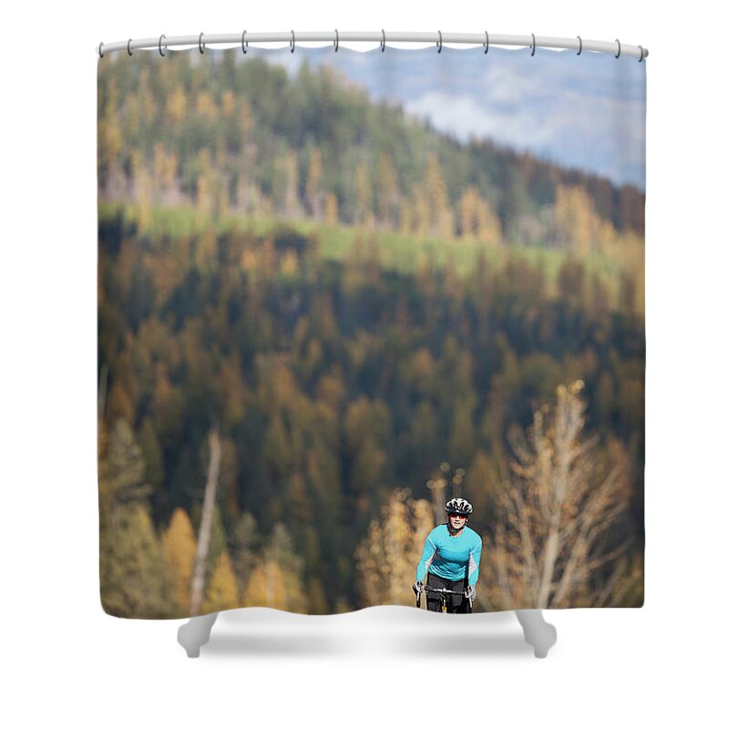 Scenics Shower Curtain featuring the photograph Usa, Montana, Whitefish, Woman Cycling by Noah Clayton