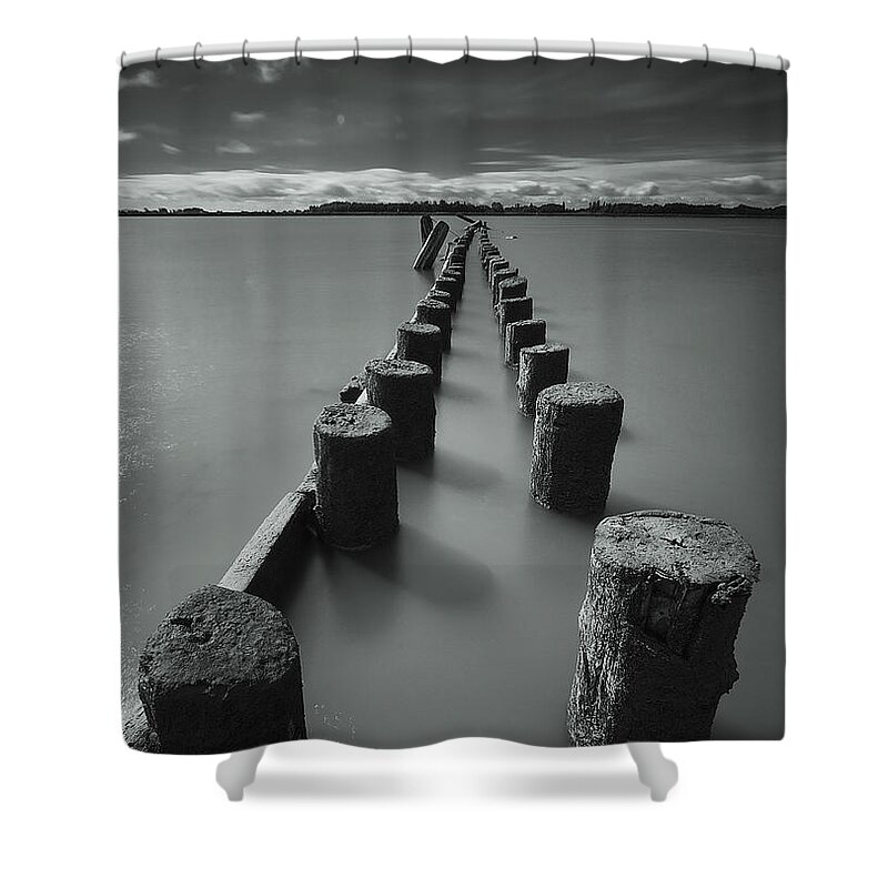 Tranquility Shower Curtain featuring the photograph Wooden Posts Leading Out Into The River by James Ingham / Design Pics