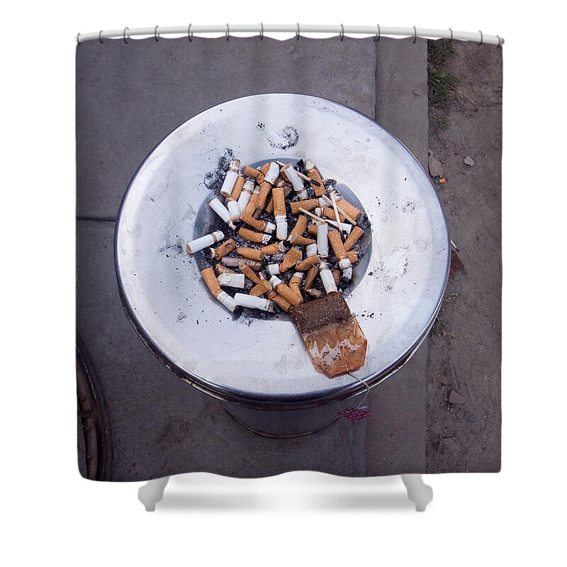Stubs Shower Curtain featuring the photograph A lot of cigarettes stubbed out at a garbage bin by Ashish Agarwal
