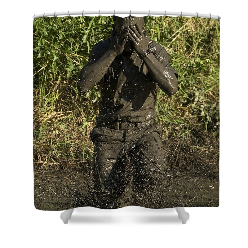 Physical Training Shower Curtain featuring the photograph A Participant Wipes Mud From His Face by Stocktrek Images