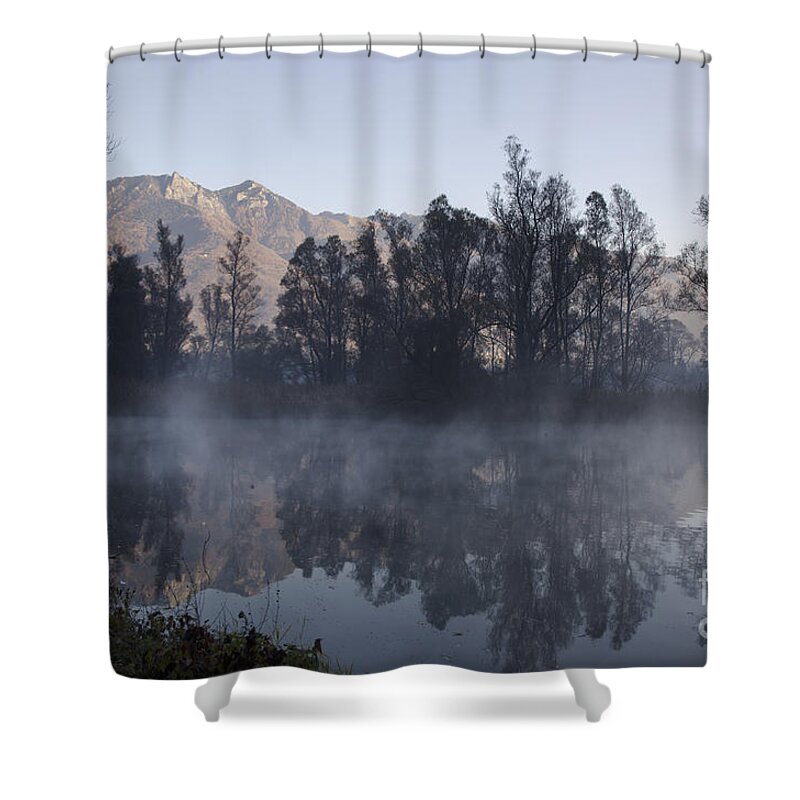 Lake Shower Curtain featuring the photograph Mountain and trees reflected in a foggy lake by Mats Silvan