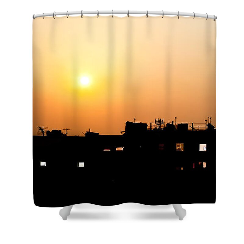 Night Shower Curtain featuring the photograph Sunset over rooftops with building lights by Simon Bratt