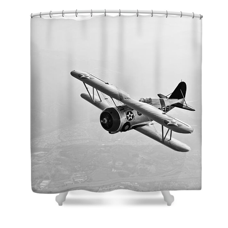Black And White Shower Curtain featuring the photograph A Grumman F3f Biplane In Flight #1 by Scott Germain