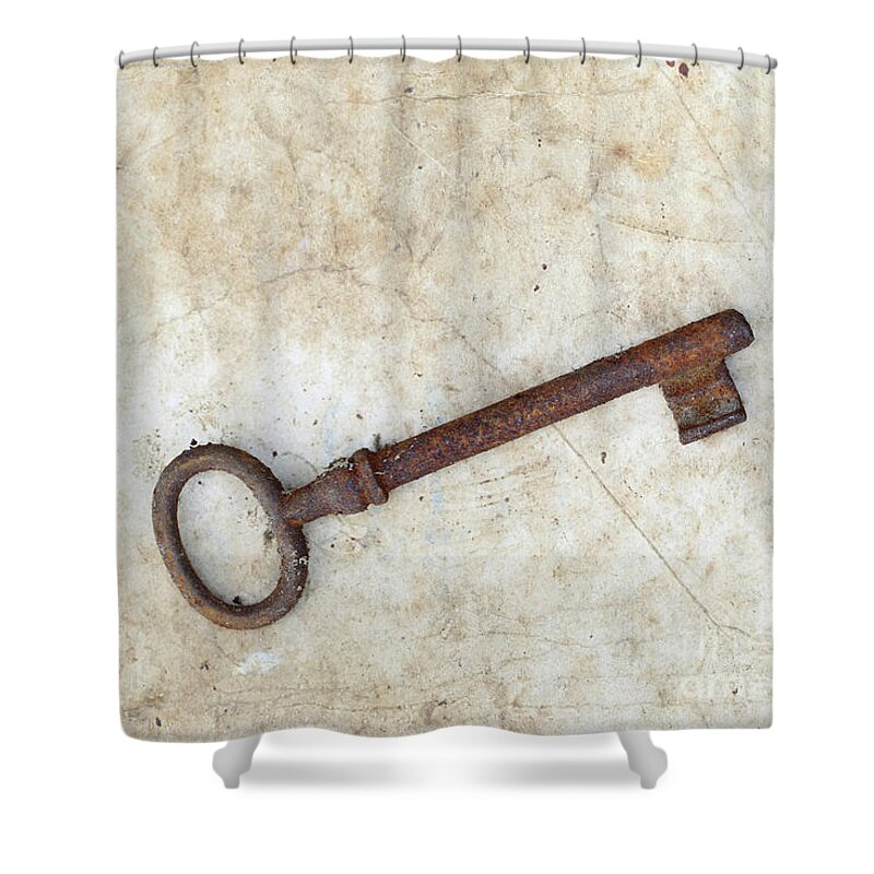 Key Shower Curtain featuring the photograph Rusty key on old parchment #1 by Michal Boubin
