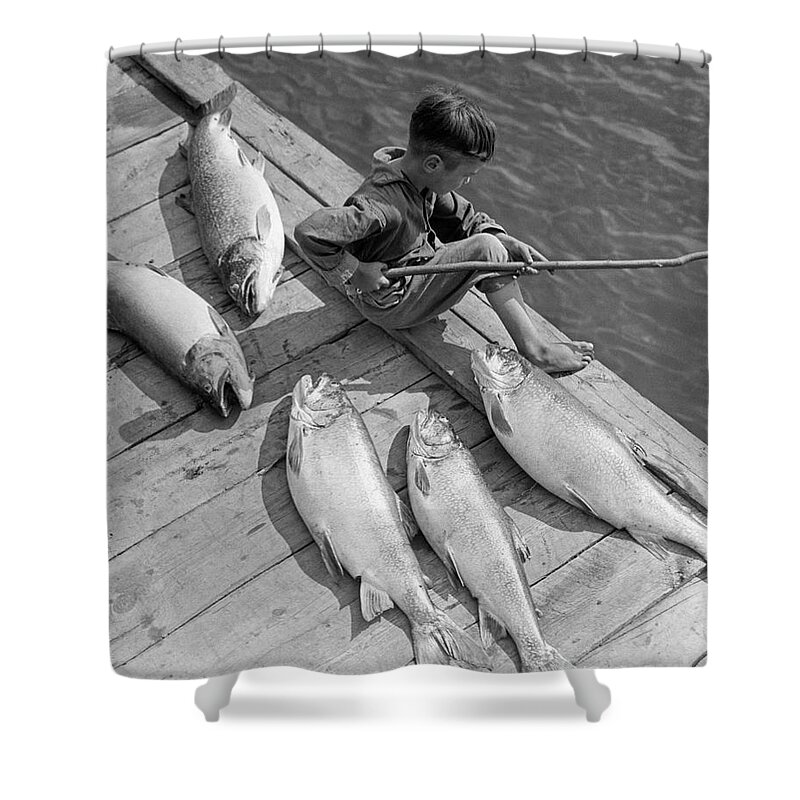 1930s Shower Curtain featuring the photograph Boy On Dock With Caught Fish by H. Armstrong Roberts/ClassicStock