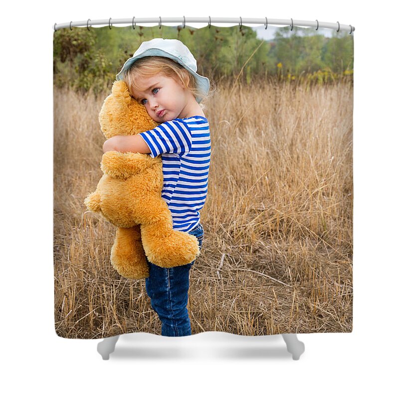 girl hugging a big teddy bear