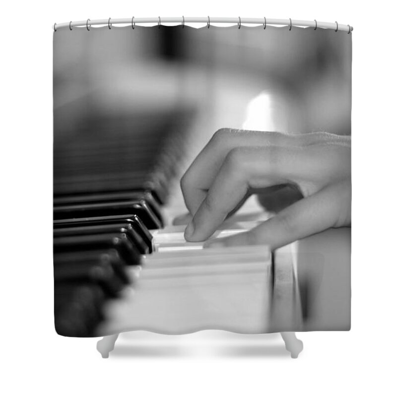 Playing Piano Shower Curtain featuring the photograph Hand on piano keyboard by Serena King
