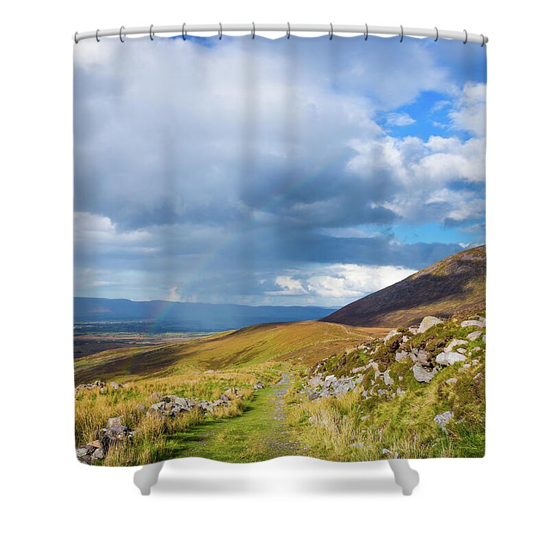 Blue Shower Curtain featuring the photograph Raining down and sunshine with rainbow on the countryside in Ire by Semmick Photo