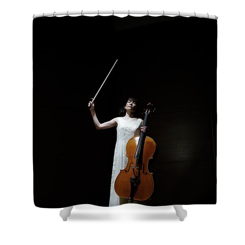 Human Arm Shower Curtain featuring the photograph A Female Cellist Raising Bow Of Cello by Sot