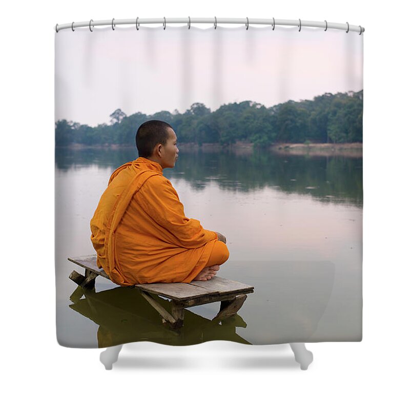 Three Quarter Length Shower Curtain featuring the photograph Buddhist Monk Sitting On Waters Edge by Martin Puddy