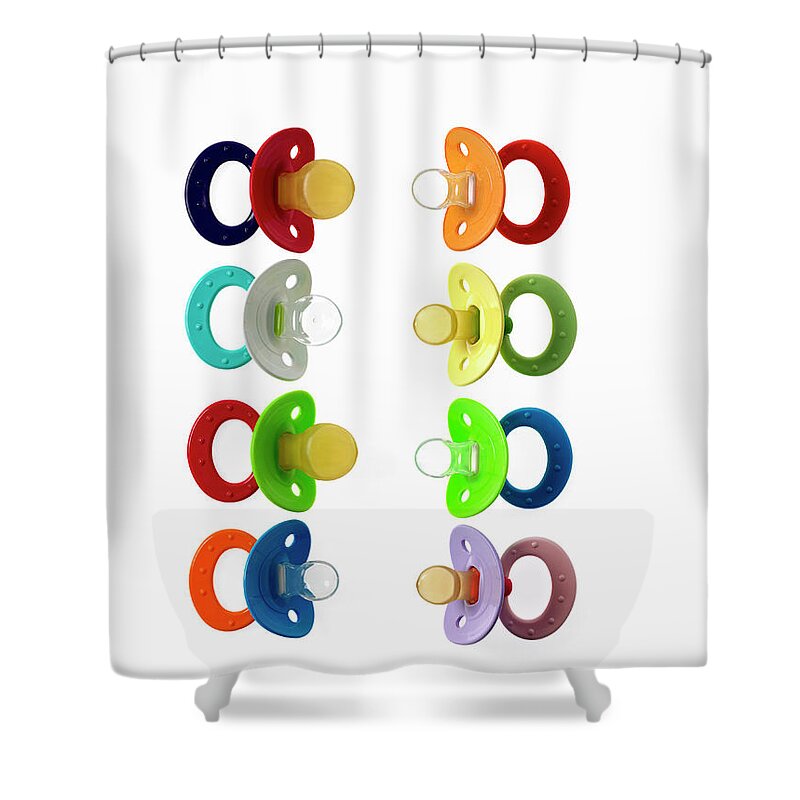 Material Shower Curtain featuring the photograph Coloured Plastic Baby Pacifiers by Mint Images - David Arky