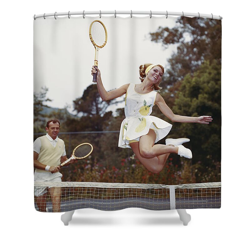 Heterosexual Couple Shower Curtain featuring the photograph Couple On Tennis Court, Woman Jumping by Tom Kelley Archive