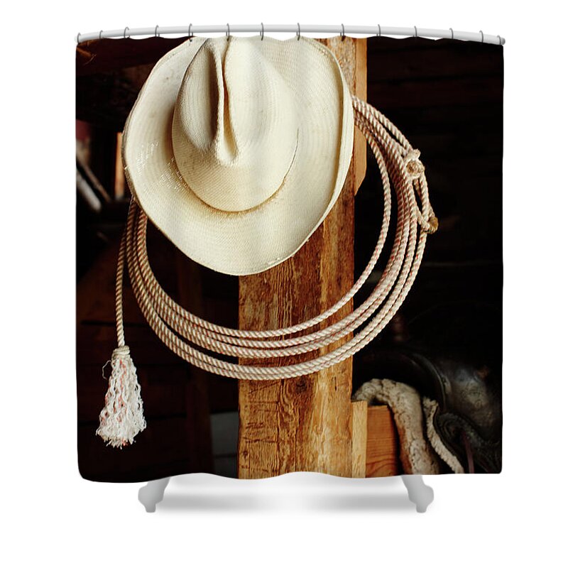 Pole Shower Curtain featuring the photograph Cowboy Hat Hanging In Barn With Rope by Nash Photos