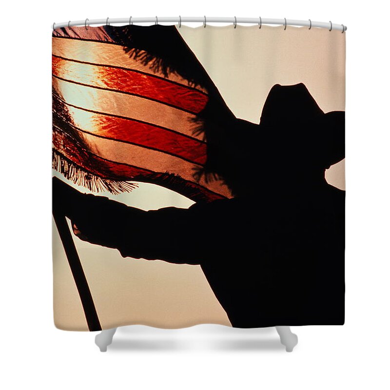One Man Only Shower Curtain featuring the photograph Cowboy Holding Stars And Stripes by Donovan Reese