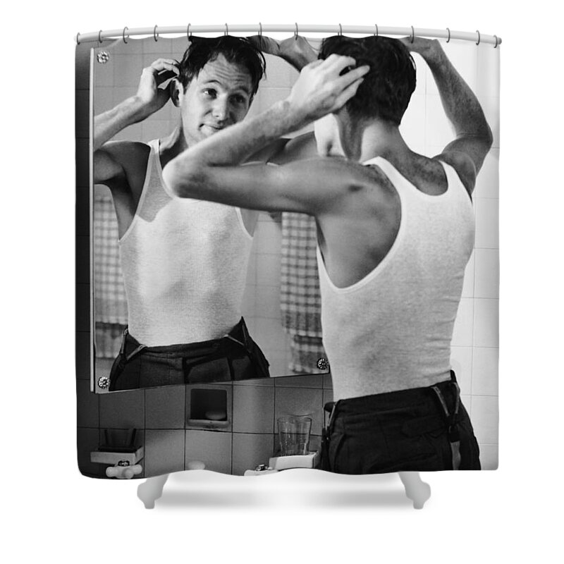 Comb Shower Curtain featuring the photograph Man Combing Hair In Bathroom by George Marks