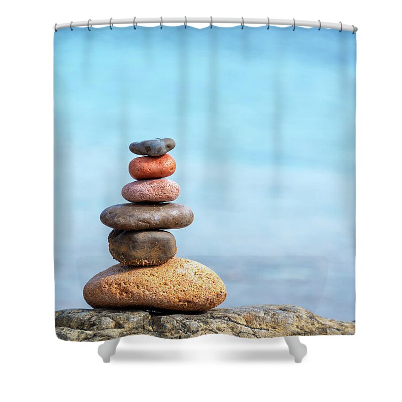 Balanced Shower Curtain featuring the photograph Pile of beach pebbles by Delphimages Photo Creations